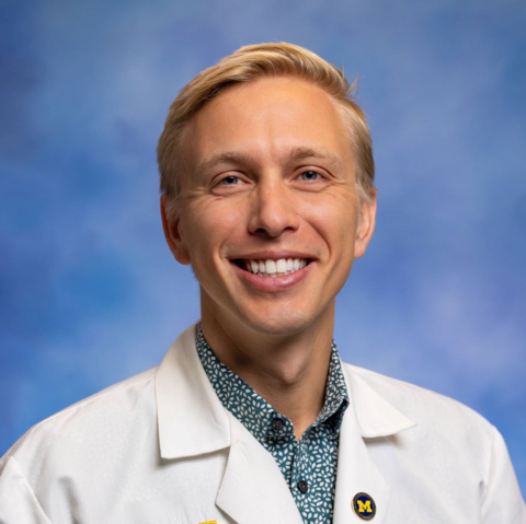 Blonde man in white doctor coat